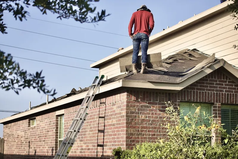 Professional roofer working on a residential roof in Cicero Center